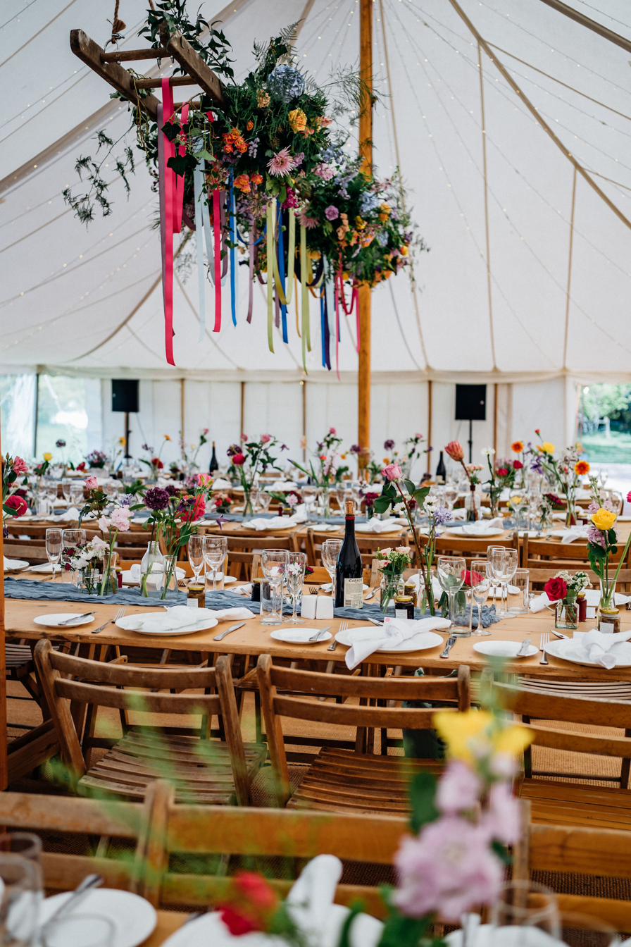 Large hanging floral installation above a marquee, Lincolnshire wedding